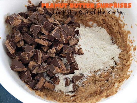 Peanut Butter Surprises | Can't Stay Out of the Kitchen | Surprise your family with these amazing #cookies. They're chocked full of #PeanutButter & #ReesesPeanutButterCups. Every bite will rock your world! Great for #tailgating or #holiday parties. #chocolate #dessert #ChocolateDessert #PeanutButterDessert #HolidayDessert #ReesesPeanutButterCupsDessert #PeanutButterSurprises