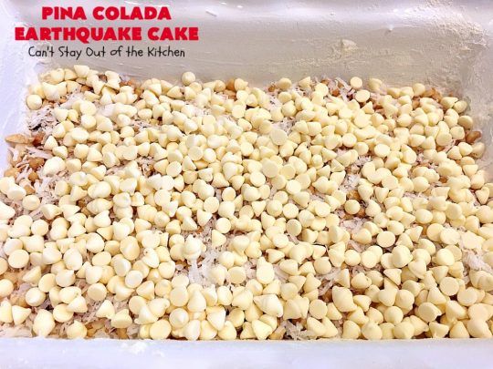 Pina Colada Earthquake Cake | Can't Stay Out of the Kitchen | best #cake ever! This heavenly #dessert is filled with #pineapple, #coconut, macadamia nuts & vanilla chips. #Creamcheese frosting bakes into the cake causing it to crater, erupt & explode in an earthquake! Perfect for #holidays or special occasions. 