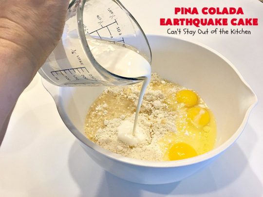 Pina Colada Earthquake Cake | Can't Stay Out of the Kitchen | best #cake ever! This heavenly #dessert is filled with #pineapple, #coconut, macadamia nuts & vanilla chips. #Creamcheese frosting bakes into the cake causing it to crater, erupt & explode in an earthquake! Perfect for #holidays or special occasions. 