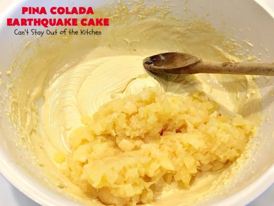 Pina Colada Earthquake Cake | Can't Stay Out of the Kitchen | best #cake ever! This heavenly #dessert is filled with #pineapple, #coconut, macadamia nuts & vanilla chips. #Creamcheese frosting bakes into the cake causing it to crater, erupt & explode in an earthquake! Perfect for #holidays or special occasions. 