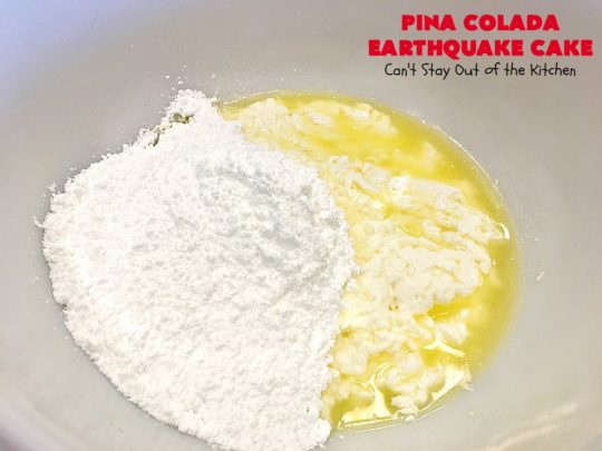Pina Colada Earthquake Cake | Can't Stay Out of the Kitchen | best #cake ever! This heavenly #dessert is filled with #pineapple, #coconut, macadamia nuts & vanilla chips. #Creamcheese frosting bakes into the cake causing it to crater, erupt & explode in an earthquake! Perfect for #holidays or special occasions. 
