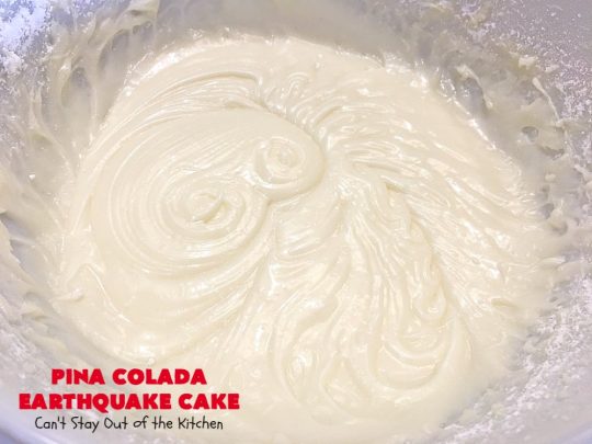 Pina Colada Earthquake Cake | Can't Stay Out of the Kitchen | best #cake ever! This heavenly #dessert is filled with #pineapple, #coconut, macadamia nuts & vanilla chips. #Creamcheese frosting bakes into the cake causing it to crater, erupt & explode in an earthquake! Perfect for #holidays or special occasions. 