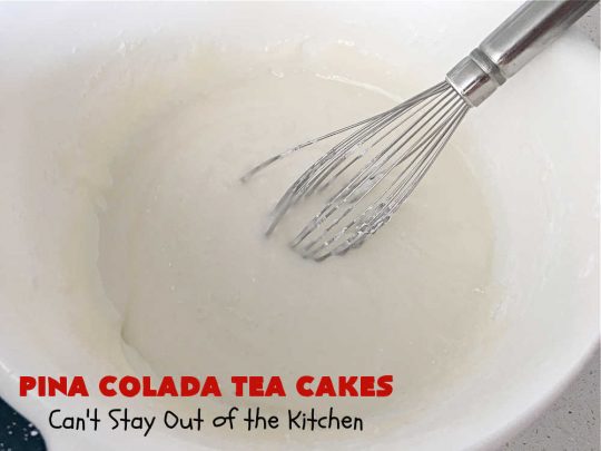 Pina Colada Tea Cakes | Can't Stay Out of the Kitchen | these scrumptious #TeaCakes are packed with #PinaColada flavor including a #Pineapple cake mix, pineapple gelatin, vanilla chips & #coconut. They're glazed with a luscious powdered sugar icing too. These miniature #Bundt #cakes are marvelous for #holiday or #Christmas baking. #HolidayDessert #PinaColadaDessert #PinaColadaTeaCakes