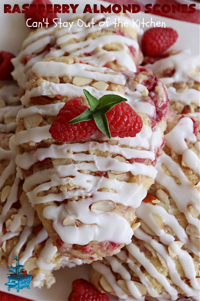 Raspberry Almond Scones | Can't Stay Out of the Kitchen | these delicious #scones are a perfect idea for a company or #holiday #breakfast, like #Thanksgiving or #Christmas. They're filled with fresh #raspberries, sliced #almonds & include #AlmondExtract in the batter as well as the icing. Every bite will rock your world! If you enjoy a sweet treat with your morning coffee, you'll love these! #RaspberryAlmondScones