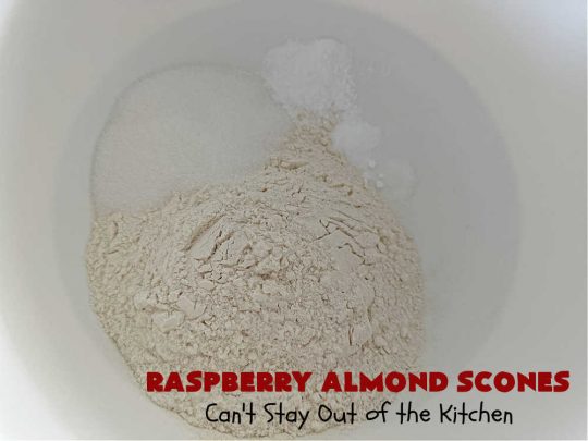 Raspberry Almond Scones | Can't Stay Out of the Kitchen | these delicious #scones are a perfect idea for a company or #holiday #breakfast, like #Thanksgiving or #Christmas. They're filled with fresh #raspberries, sliced #almonds & include #AlmondExtract in the batter as well as the icing. Every bite will rock your world! If you enjoy a sweet treat with your morning coffee, you'll love these! #RaspberryAlmondScones