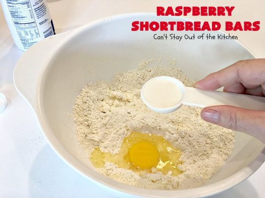 Raspberry Shortbread Bars | Can't Stay Out of the Kitchen | these #cookie type bars are absolutely divine! They have a shortbread crust, topped with #raspberry preserves & a #coconut topping. You'll be drooling over every bite! #dessert