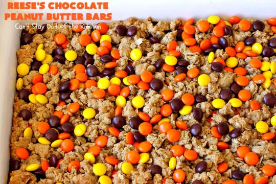 Reese's Chocolate Peanut Butter Bars | Can't Stay Out of the Kitchen | these outrageous #cookies start with an #OatmealCookie & #PeanutButter crust & topping. They have a #chocolate sauce & #ReesesPeanutButterCandies in the middle. Absolutely awesome! #tailgating #brownie #dessert #ChocolateDessert #PeanutButterDessert #ReesesPeanutButterDessert #ReesesChocolatePeanutButterBars