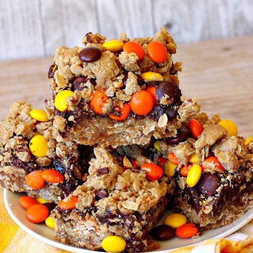 Reese's Chocolate Peanut Butter Bars | Can't Stay Out of the Kitchen | these outrageous #cookies start with an #OatmealCookie & #PeanutButter crust & topping. They have a #chocolate sauce & #ReesesPeanutButterCandies in the middle. Absolutely awesome! #tailgating #brownie #dessert #ChocolateDessert #PeanutButterDessert #ReesesPeanutButterDessert #ReesesChocolatePeanutButterBars