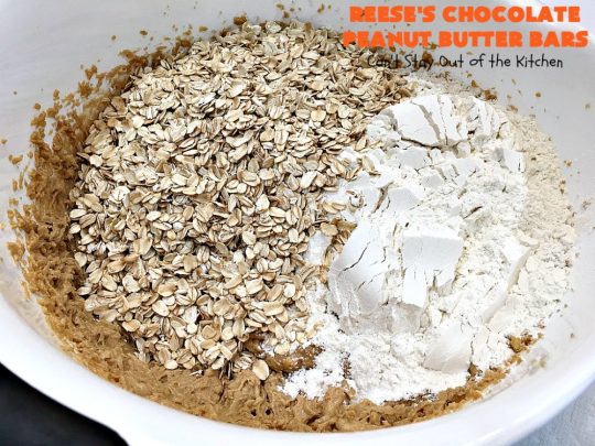 Reese's Chocolate Peanut Butter Bars | Can't Stay Out of the Kitchen | these outrageous #cookies start with an #OatmealCookie & #PeanutButter crust & topping. They have a #chocolate sauce & #ReesesPeanutButterCandies in the middle. Absolutely awesome! #tailgating #brownie #dessert #ChocolateDessert #PeanutButterDessert #ReesesPeanutButterDessert #ReesesChocolatePeanutButterBars