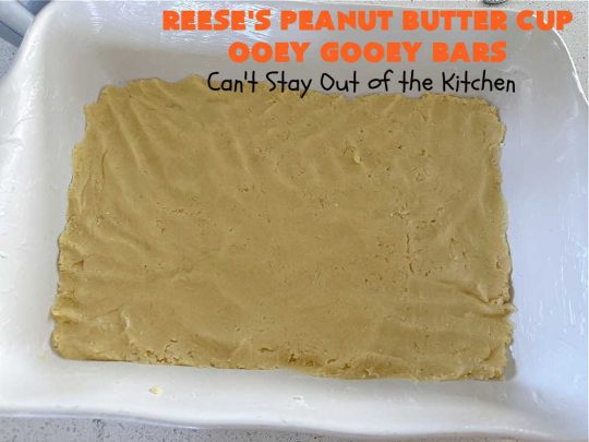 Reese's Peanut Butter Cup Ooey Gooey Bars | Can't Stay Out of the Kitchen | This fabulous #OoeyGooeyBar #recipe uses only 6 ingredients! It has a luscious #cheesecake filling & it's topped with #ReesesPeanutButterCups. Every bite will have you swooning! Great for #holiday #baking, #tailgating parties, a #ChristmasCookieExchange or any time you just need #chocolate! #PeanutButter #dessert #brownie #cookie #CreamCheese #ReesesPeanutButterCupOoeyGooeyBars