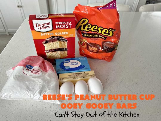 Reese's Peanut Butter Cup Ooey Gooey Bars | Can't Stay Out of the Kitchen | This fabulous #OoeyGooeyBar #recipe uses only 6 ingredients! It has a luscious #cheesecake filling & it's topped with #ReesesPeanutButterCups. Every bite will have you swooning! Great for #holiday #baking, #tailgating parties, a #ChristmasCookieExchange or any time you just need #chocolate! #PeanutButter #dessert #brownie #cookie #CreamCheese #ReesesPeanutButterCupOoeyGooeyBars