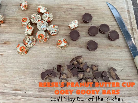 Reese's Peanut Butter Cup Ooey Gooey Bars | Can't Stay Out of the Kitchen | This fabulous #OoeyGooeyBar #recipe uses only 6 ingredients! It has a luscious #cheesecake filling & it's topped with #ReesesPeanutButterCups. Every bite will have you swooning! Great for #holiday #baking, #tailgating parties, a #ChristmasCookieExchange or any time you just need #chocolate! #PeanutButter #dessert #brownie #cookie #CreamCheese #ReesesPeanutButterCupOoeyGooeyBars