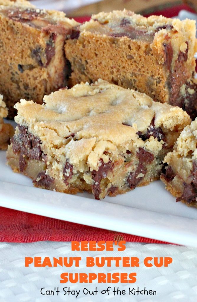 Reese's Peanut Butter Cup Surprises | Can't Stay Out of the Kitchen | these awesome #brownies have #ReesesPeanutButterCups tucked away between two layers of #MrsFieldsChocolateChipCookie dough. They are rich, decadent & absolutely heavenly. Perfect for #tailgating parties, a company #dessert or a #ChristmasCookieExchange. #PeanutButter #PeanutButterCups #chocolate #ReesesPeanutButterCupSurprises