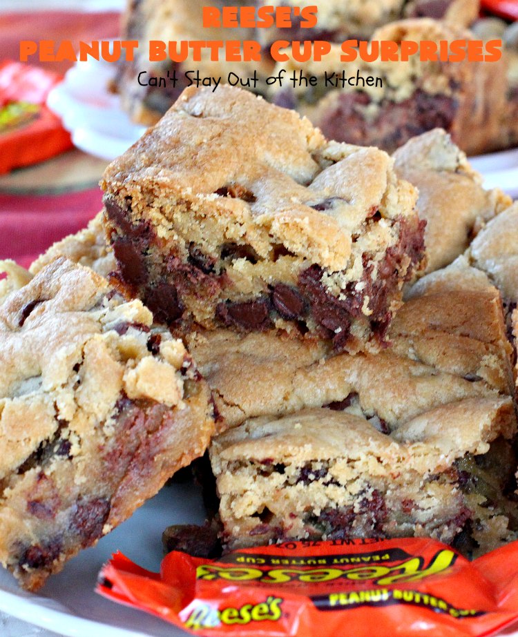 Reese's Peanut Butter Cup Surprises | Can't Stay Out of the Kitchen | these awesome #brownies have #ReesesPeanutButterCups tucked away between two layers of #MrsFieldsChocolateChipCookie dough. They are rich, decadent & absolutely heavenly. Perfect for #tailgating parties, a company #dessert or a #ChristmasCookieExchange. #PeanutButter #PeanutButterCups #chocolate #ReesesPeanutButterCupSurprises