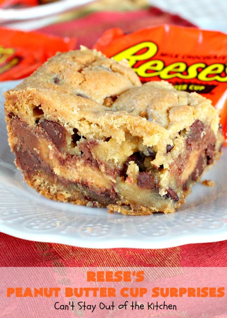 Reese's Peanut Butter Cup Surprises | Can't Stay Out of the Kitchen | these awesome #brownies have #ReesesPeanutButterCups tucked away between two layers of #MrsFieldsChocolateChipCookie dough. They are rich, decadent & absolutely heavenly. Perfect for #tailgating parties, a company #dessert or a #ChristmasCookieExchange. #PeanutButter #PeanutButterCups #chocolate #ReesesPeanutButterCupSurprises