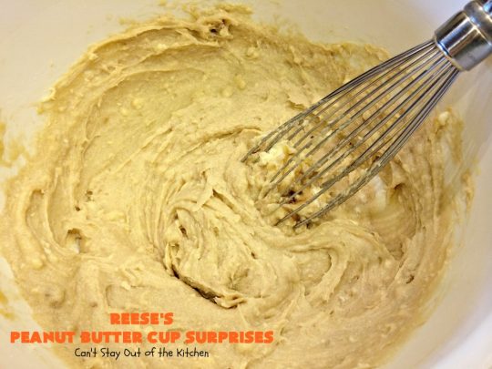 Reese's Peanut Butter Cup Surprises | Can't Stay Out of the Kitchen | these awesome #brownies have #ReesesPeanutButterCups tucked away between two layers of #MrsFieldsChocolateChipCookie dough. They are rich, decadent & absolutely heavenly. Perfect for #tailgating parties, a company #dessert or a #ChristmasCookieExchange. #PeanutButter #PeanutButterCups #chocolate #ReesesPeanutButterCupSurprises