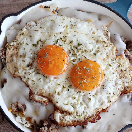 Sausage and Gravy Breakfast Skillet | Can't Stay Out of the Kitchen | this fantastic #BreakfastSkillet includes #SausageAndGravy which offers a down-home #southern #breakfast you're sure to love. This one includes #HashBrowns, both #Cheddar & #MontereyJack cheeses and sunny-side-up #eggs. Hearty, filling & so satisfying. Great for a weekend, company or #HolidayBreakfast. #holiday #FathersDay #FathersDayBreakfast #sausage #SausageAndGravyBreakfastSkillet