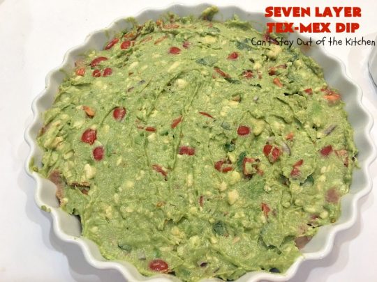 Seven Layer Tex-Mex Dip | Can't Stay Out of the Kitchen | this awesome #TexMex #dip is out of this world. It's terrific for any kind of company or #holiday party. We like it for #tailgating parties & potlucks. Also great for summer #holidays like #FourthOfJuly. #GlutenFree #Mexican #TexMexDip #LayeredMexicanDip #RefriedBeans #Jalapenos #Olives #CheddarCheese #Guacamole #TortillaChips #tomatoes #Avocados #SevenLayerTexMexDip #appetizer #TexMexAppetizer
