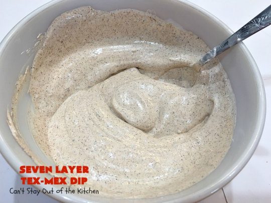 Seven Layer Tex-Mex Dip | Can't Stay Out of the Kitchen | this awesome #TexMex #dip is out of this world. It's terrific for any kind of company or #holiday party. We like it for #tailgating parties & potlucks. Also great for summer #holidays like #FourthOfJuly. #GlutenFree #Mexican #TexMexDip #LayeredMexicanDip #RefriedBeans #Jalapenos #Olives #CheddarCheese #Guacamole #TortillaChips #tomatoes #Avocados #SevenLayerTexMexDip #appetizer #TexMexAppetizer