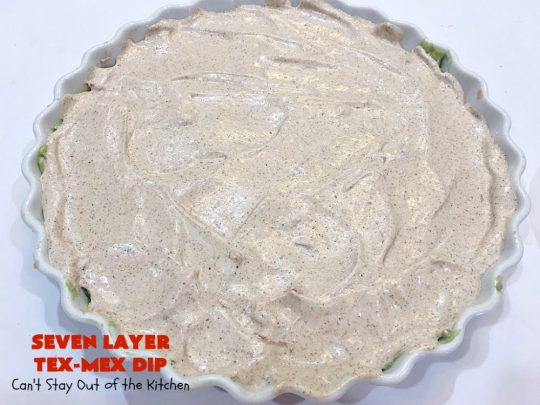 Seven Layer Tex-Mex Dip | Can't Stay Out of the Kitchen | this awesome #TexMex #dip is out of this world. It's terrific for any kind of company or #holiday party. We like it for #tailgating parties & potlucks. Also great for summer #holidays like #FourthOfJuly. #GlutenFree #Mexican #TexMexDip #LayeredMexicanDip #RefriedBeans #Jalapenos #Olives #CheddarCheese #Guacamole #TortillaChips #tomatoes #Avocados #SevenLayerTexMexDip #appetizer #TexMexAppetizer