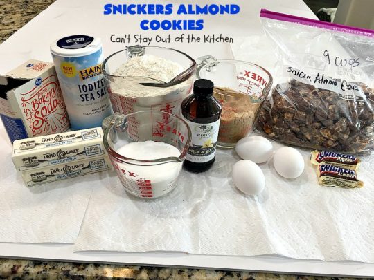 Snickers Almond Cookies | Can't Stay Out of the Kitchen | these scrumptious #cookies will cure any sweet tooth craving. This #dessert uses #SnickersAlmondBars in the dough. So they're filled with #chocolate & #almonds. Every bite will have you salivating. #tailgating #holiday #baking #HolidayBaking #HolidayDessert #SnickersDessert #ChocolateDessert #AlmondDessert #ChristmasCookieExchange #Snickers #SnickersBars #SnickersAlmondCookies
