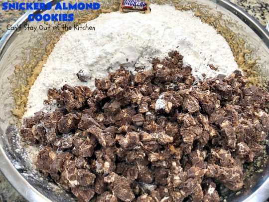 Snickers Almond Cookies | Can't Stay Out of the Kitchen | these scrumptious #cookies will cure any sweet tooth craving. This #dessert uses #SnickersAlmondBars in the dough. So they're filled with #chocolate & #almonds. Every bite will have you salivating. #tailgating #holiday #baking #HolidayBaking #HolidayDessert #SnickersDessert #ChocolateDessert #AlmondDessert #ChristmasCookieExchange #Snickers #SnickersBars #SnickersAlmondCookies