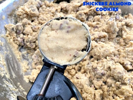 Snickers Almond Cookies | Can't Stay Out of the Kitchen | these scrumptious #cookies will cure any sweet tooth craving. This #dessert uses #SnickersAlmondBars in the dough. So they're filled with #chocolate & #almonds. Every bite will have you salivating. #tailgating #holiday #baking #HolidayBaking #HolidayDessert #SnickersDessert #ChocolateDessert #AlmondDessert #ChristmasCookieExchange #Snickers #SnickersBars #SnickersAlmondCookies