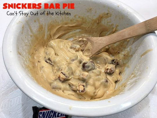 Snickers Bar Pie | Can't Stay Out of the Kitchen | this outrageously irresistible #pie is filled with #SnickersBars. Every bite contains #chocolate, #caramel & #peanuts. Fantastic for special occasions & #holidays like #ValentinesDay. #CaramelDessert #ChocolateDessert #HolidayDessert #PeanutButterDessert #SnickersDessert #SnickersCandyBars #SnickersBarPie #dessert