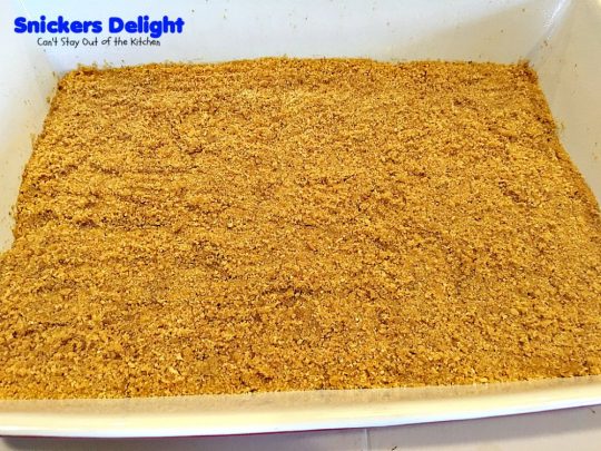 Snickers Delight | Can't Stay Out of the Kitchen | fantastic #icecream #dessert with a graham cracker crust, a #snickers ice cream & #chocolate pudding layer & topped with chopped Snickers bars. This will become your favorite dessert!