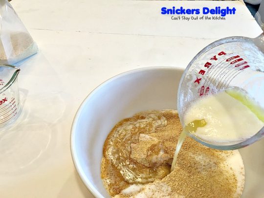 Snickers Delight | Can't Stay Out of the Kitchen | fantastic #icecream #dessert with a graham cracker crust, a #snickers ice cream & #chocolate pudding layer & topped with chopped Snickers bars. This will become your favorite dessert!