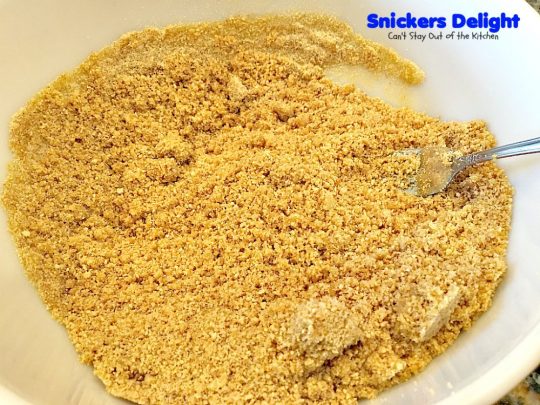 Snickers Delight | Can't Stay Out of the Kitchen | fantastic #icecream #dessert with a graham cracker crust, a #snickers ice cream & #chocolate pudding layer & topped with chopped Snickers bars. This will become your favorite dessert!
