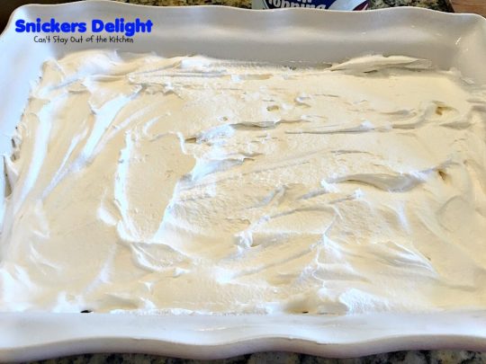 Snickers Delight | Can't Stay Out of the Kitchen | fantastic #icecream #dessert with a graham cracker crust, a #snickers ice cream & #chocolate pudding layer & topped with chopped Snickers bars. This will become your favorite dessert!