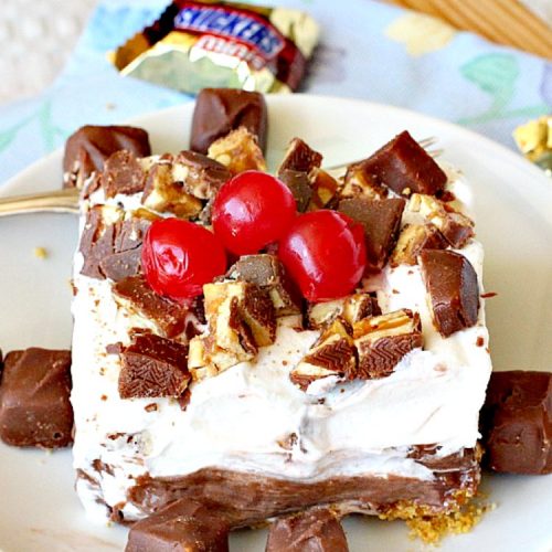 Snickers Delight | Can't Stay Out of the Kitchen | fantastic #icecream #dessert with a graham cracker crust, a #snickers ice cream & #chocolate pudding layer & topped with chopped Snickers bars. This will become your favorite dessert!