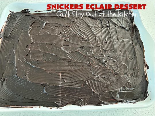 Snickers Éclair Dessert | Can't Stay Out of the Kitchen | this easy-peasy 6-ingredient #recipe is spectacular for company, potlucks or special occasions like #ValentinesDay. It includes layers of #ChocolatePudding, #GrahamCrackers, #ChocolateIcing and #SnickersCandyBars on top. The #Snickers give it that wonderful chocolaty & #caramel flavor along with #peanuts that adds a little punch to the #dessert. So easy even a child can make it! #Éclairs #ÉclairDessert #SnickersÉclairDessert