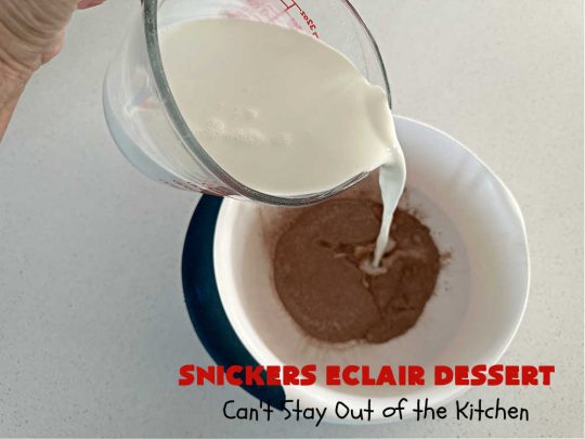 Snickers Éclair Dessert | Can't Stay Out of the Kitchen | this easy-peasy 6-ingredient #recipe is spectacular for company, potlucks or special occasions like #ValentinesDay. It includes layers of #ChocolatePudding, #GrahamCrackers, #ChocolateIcing and #SnickersCandyBars on top. The #Snickers give it that wonderful chocolaty & #caramel flavor along with #peanuts that adds a little punch to the #dessert. So easy even a child can make it! #Éclairs #ÉclairDessert #SnickersÉclairDessert