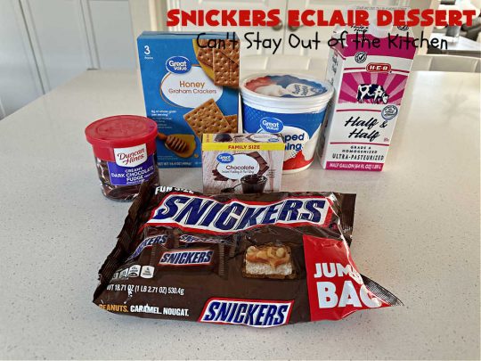 Snickers Éclair Dessert | Can't Stay Out of the Kitchen | this easy-peasy 6-ingredient #recipe is spectacular for company, potlucks or special occasions like #ValentinesDay. It includes layers of #ChocolatePudding, #GrahamCrackers, #ChocolateIcing and #SnickersCandyBars on top. The #Snickers give it that wonderful chocolaty & #caramel flavor along with #peanuts that adds a little punch to the #dessert. So easy even a child can make it! #Éclairs #ÉclairDessert #SnickersÉclairDessert