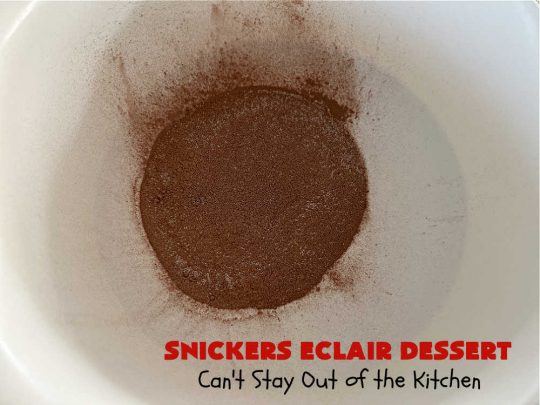 Snickers Éclair Dessert | Can't Stay Out of the Kitchen | this easy-peasy 6-ingredient #recipe is spectacular for company, potlucks or special occasions like #ValentinesDay. It includes layers of #ChocolatePudding, #GrahamCrackers, #ChocolateIcing and #SnickersCandyBars on top. The #Snickers give it that wonderful chocolaty & #caramel flavor along with #peanuts that adds a little punch to the #dessert. So easy even a child can make it! #Éclairs #ÉclairDessert #SnickersÉclairDessert