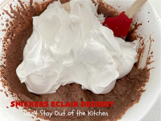 Snickers Éclair Dessert | Can't Stay Out of the Kitchen | this easy-peasy 6-ingredient #recipe is spectacular for company, potlucks or special occasions like #ValentinesDay. It includes layers of #ChocolatePudding, #GrahamCrackers, #ChocolateIcing and #SnickersCandyBars on top. The #Snickers give it that wonderful chocolaty & #caramel flavor along with #peanuts that adds a little punch to the #dessert. So easy even a child can make it! #Éclairs #ÉclairDessert #SnickersÉclairDessert