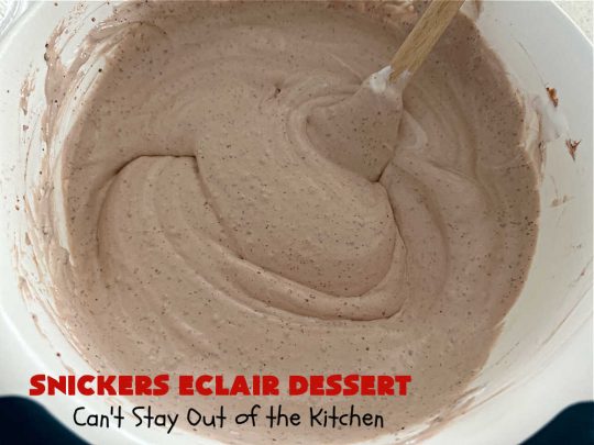 Snickers Éclair Dessert | Can't Stay Out of the Kitchen | this easy-peasy 6-ingredient #recipe is spectacular for company, potlucks or special occasions like #ValentinesDay. It includes layers of #ChocolatePudding, #GrahamCrackers, #ChocolateIcing and #SnickersCandyBars on top. The #Snickers give it that wonderful chocolaty & #caramel flavor along with #peanuts that adds a little punch to the #dessert. So easy even a child can make it! #Éclairs #ÉclairDessert #SnickersÉclairDessert