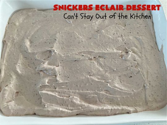 Snickers Éclair Dessert | Can't Stay Out of the Kitchen | this easy-peasy 6-ingredient #recipe is spectacular for company, potlucks or special occasions like #ValentinesDay. It includes layers of #ChocolatePudding, #GrahamCrackers, #ChocolateIcing and #SnickersCandyBars on top. The #Snickers give it that wonderful chocolaty & #caramel flavor along with #peanuts that adds a little punch to the #dessert. So easy even a child can make it! #Éclairs #ÉclairDessert #SnickersÉclairDessert