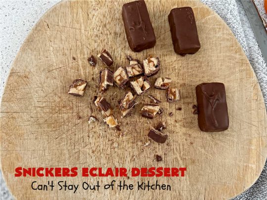 Snickers Éclair Dessert | Can't Stay Out of the Kitchen | this easy-peasy 6-ingredient #recipe is spectacular for company, potlucks or special occasions like #ValentinesDay. It includes layers of #ChocolatePudding, #GrahamCrackers, #ChocolateIcing and #SnickersCandyBars on top. The #Snickers give it that wonderful chocolaty & #caramel flavor along with #peanuts that adds a little punch to the #dessert. So easy even a child can make it! #Éclairs #ÉclairDessert #SnickersÉclairDessert
