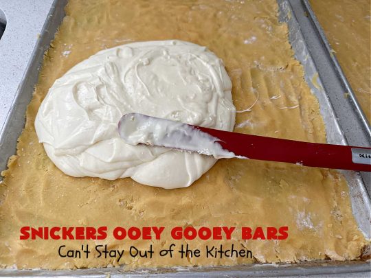 Snickers Ooey Gooey Bars | Can't Stay Out of the Kitchen | these luscious #OoeyGooeyBars contain a #cheesecake layer & they're topped with #SnickersBars for a lovely #chocolate & #PeanutButter flavor that will win over all your family & friends. This 6-ingredient #recipe is perfect for #tailgating parties, potlucks or a #ChristmasCookieExchange. It's easy to whip up & everyone loves them! #holiday #HolidayDessert #SnickersDessert #dessert #brownie #SnickersOoeyGooeyBars