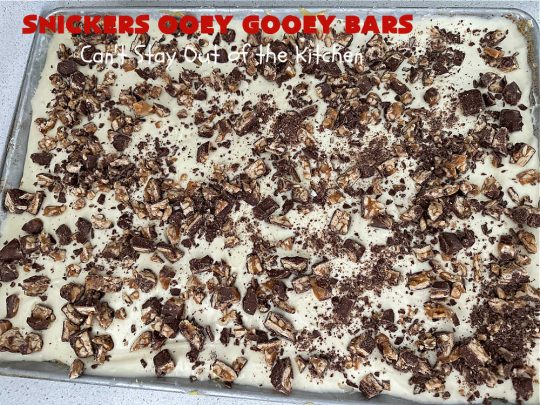 Snickers Ooey Gooey Bars | Can't Stay Out of the Kitchen | these luscious #OoeyGooeyBars contain a #cheesecake layer & they're topped with #SnickersBars for a lovely #chocolate & #PeanutButter flavor that will win over all your family & friends. This 6-ingredient #recipe is perfect for #tailgating parties, potlucks or a #ChristmasCookieExchange. It's easy to whip up & everyone loves them! #holiday #HolidayDessert #SnickersDessert #dessert #brownie #SnickersOoeyGooeyBars