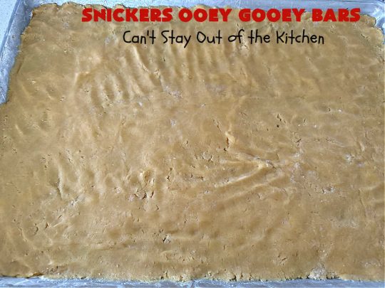 Snickers Ooey Gooey Bars | Can't Stay Out of the Kitchen | these luscious #OoeyGooeyBars contain a #cheesecake layer & they're topped with #SnickersBars for a lovely #chocolate & #PeanutButter flavor that will win over all your family & friends. This 6-ingredient #recipe is perfect for #tailgating parties, potlucks or a #ChristmasCookieExchange. It's easy to whip up & everyone loves them! #holiday #HolidayDessert #SnickersDessert #dessert #brownie #SnickersOoeyGooeyBars