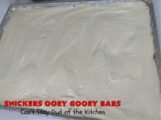 Snickers Ooey Gooey Bars | Can't Stay Out of the Kitchen | these luscious #OoeyGooeyBars contain a #cheesecake layer & they're topped with #SnickersBars for a lovely #chocolate & #PeanutButter flavor that will win over all your family & friends. This 6-ingredient #recipe is perfect for #tailgating parties, potlucks or a #ChristmasCookieExchange. It's easy to whip up & everyone loves them! #holiday #HolidayDessert #SnickersDessert #dessert #brownie #SnickersOoeyGooeyBars