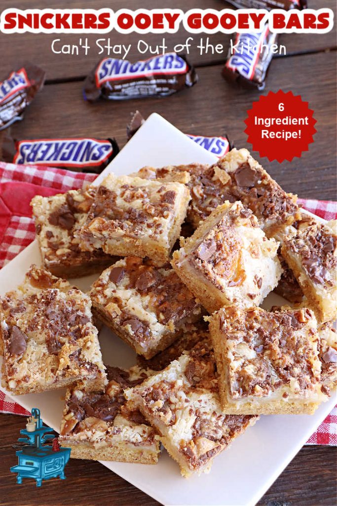 Snickers Ooey Gooey Bars | Can't Stay Out of the Kitchen | these luscious #OoeyGooeyBars contain a #cheesecake layer & they're topped with #SnickersBars for a lovely #chocolate & #PeanutButter flavor that will win over all your family & friends. This 6-ingredient #recipe is perfect for #tailgating parties, potlucks or a #ChristmasCookieExchange. It's easy to whip up & everyone loves them! #holiday #HolidayDessert #SnickersDessert #dessert #brownie #SnickersOoeyGooeyBars