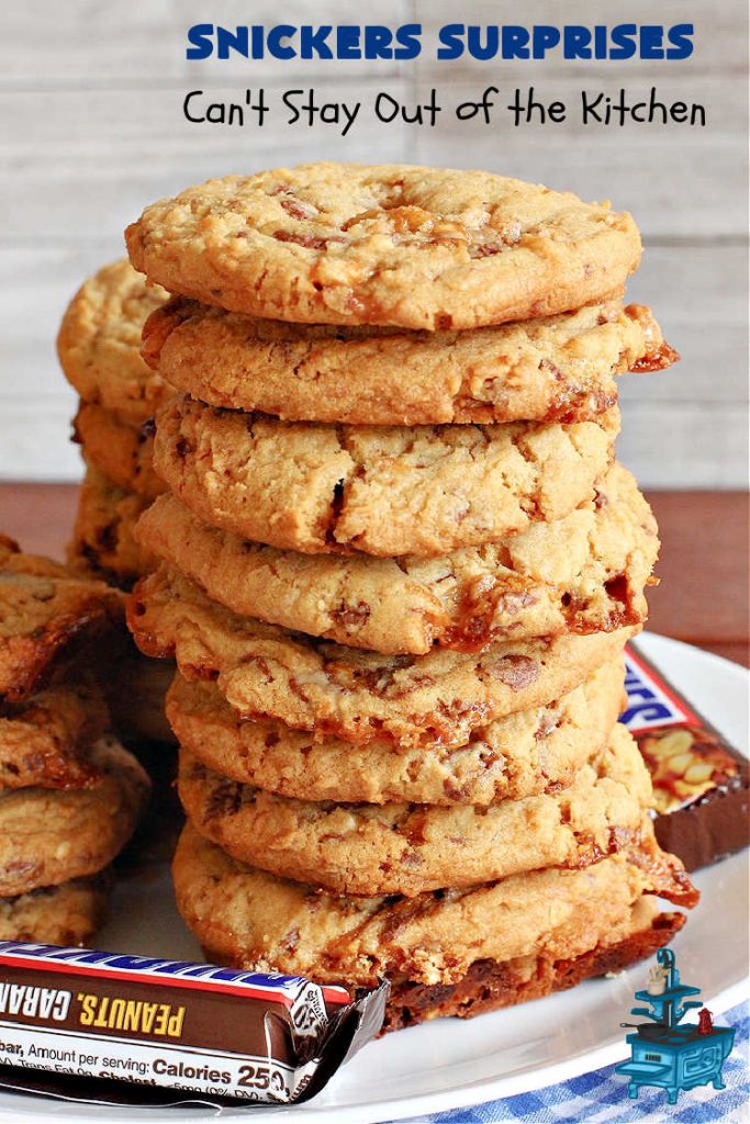Snickers Surprises | Can't Stay Out of the Kitchen | these scrumptious #PeanutButterCookies include #SnickersBars so they have a little bit of #caramel, #chocolate & #PeanutButter in every bite. You're sure to swoon once you get a taste of these jewels. Perfect for #tailgating, potlucks, backyard BBQs and #holiday #baking. #ChristmasCookieExchange #dessert #ChocolateDessert #SnickersDessert #PeanutButterDessert #CaramelDessert #cookies #SnickersSurprises