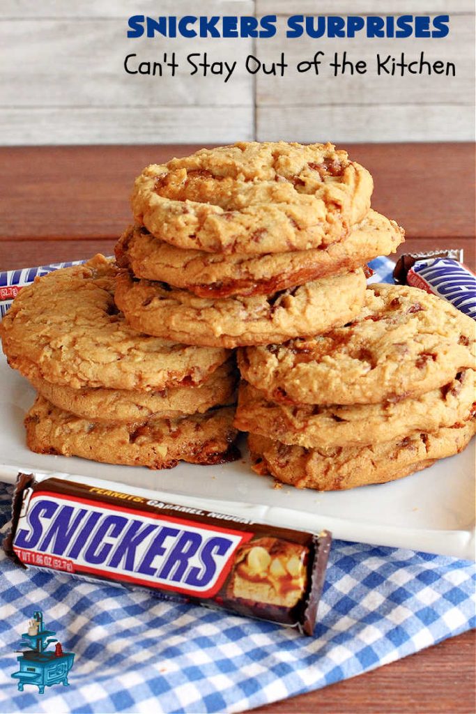 Snickers Surprises | Can't Stay Out of the Kitchen | these scrumptious #PeanutButterCookies include #SnickersBars so they have a little bit of #caramel, #chocolate & #PeanutButter in every bite. You're sure to swoon once you get a taste of these jewels. Perfect for #tailgating, potlucks, backyard BBQs and #holiday #baking. #ChristmasCookieExchange #dessert #ChocolateDessert #SnickersDessert #PeanutButterDessert #CaramelDessert #cookies #SnickersSurprises