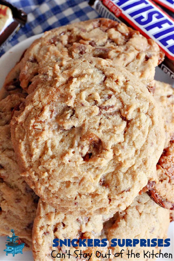 Snickers Surprises | Can't Stay Out of the Kitchen | these scrumptious #PeanutButterCookies include #SnickersBars so they have a little bit of #caramel, #chocolate & #PeanutButter in every bite. You're sure to swoon once you get a taste of these jewels. Perfect for #tailgating, potlucks, backyard BBQs and #holiday #baking. #ChristmasCookieExchange #dessert #ChocolateDessert #SnickersDessert #PeanutButterDessert #CaramelDessert #cookies #SnickersSurprises