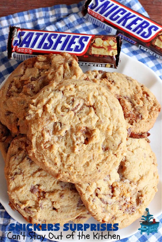 Snickers Surprises | Can't Stay Out of the Kitchen | these scrumptious #PeanutButterCookies include #SnickersBars so they have a little bit of #caramel, #chocolate & #PeanutButter in every bite. You're sure to swoon once you get a taste of these jewels. Perfect for #tailgating, potlucks, backyard BBQs and #holiday #baking. #ChristmasCookieExchange #dessert #ChocolateDessert #SnickersDessert #PeanutButterDessert #CaramelDessert #cookies #SnickersSurprises